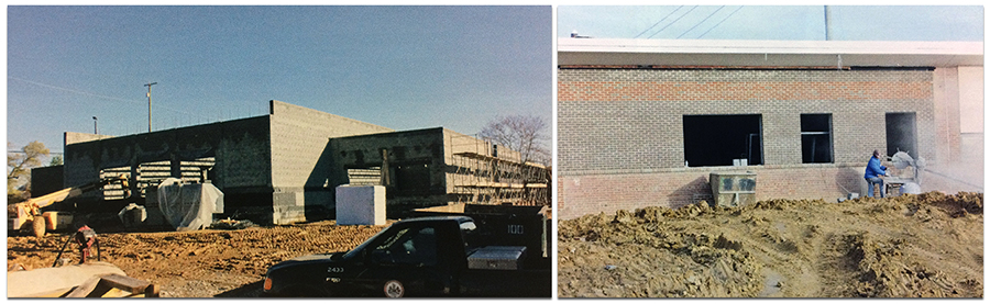Two color photographs from Garfield's 2013 yearbook showing construction on the new wing of the building. The photograph on the left shows the cinderblock walls that have been erected, but there is still no roof on the structure. Construction equipment and vehicles are stationed around the building. The photograph on the right shows a construction worker cutting bricks to fit around a window frame. The brick veneer on the outside of the building is in place, as is the roof. 