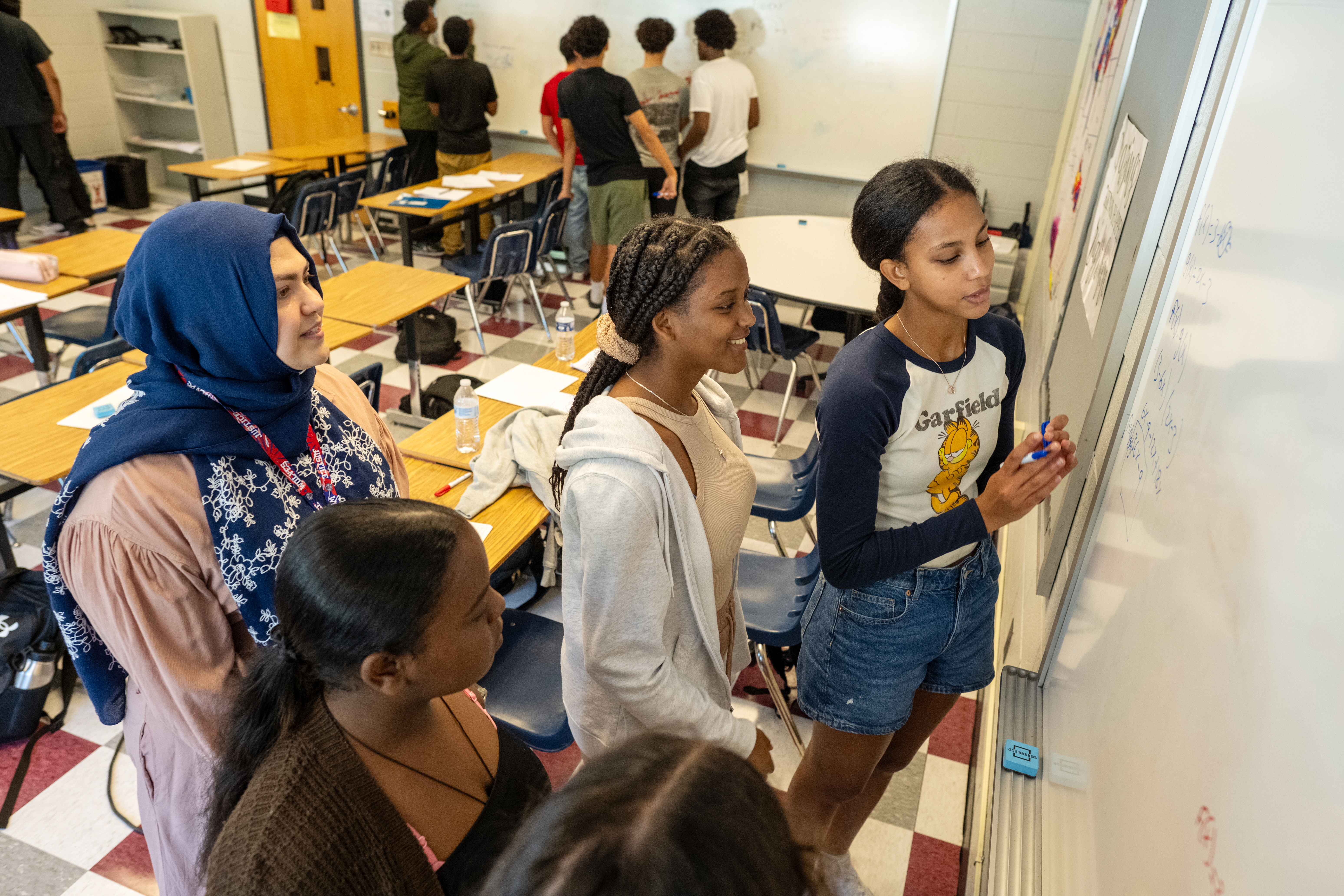 students writing on the board at Garfield