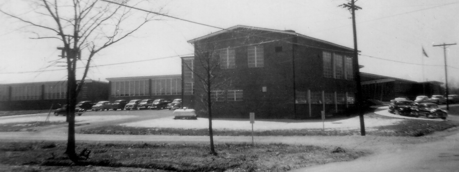 Black and white photograph of Garfield Elementary School taken in 1954 for a fire insurance survey for the Fairfax County School Board. The picture was taken from Old Keene Mill Road and faces the east side of the building. This side of the school looks very similar today, except the main entrance has been moved to face Spring Road. 